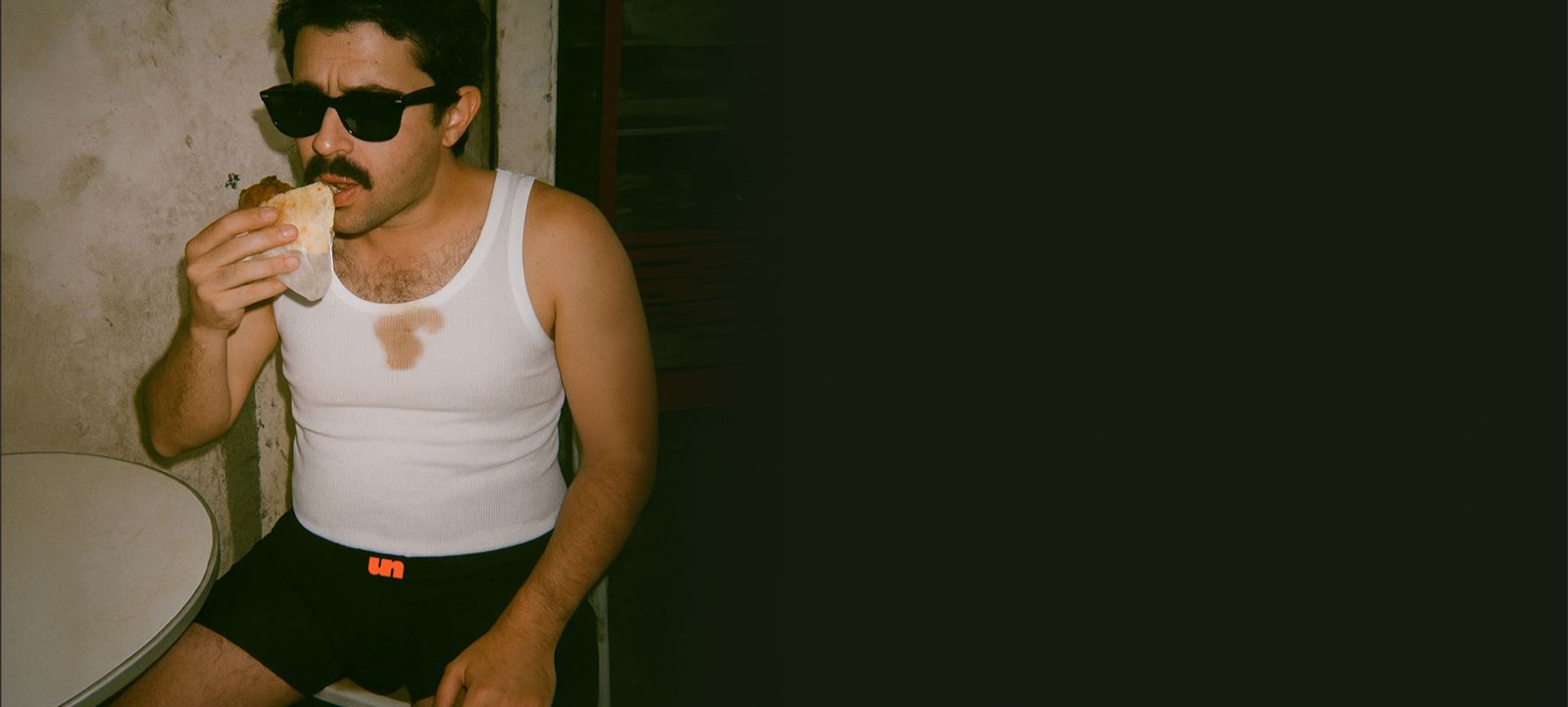 Man Wearing Sunglasses, Eating falafel, sitting in Unluckies MicroModal Original Boxers